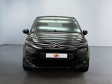the front of a black citrole parked in a white room
