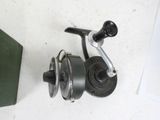 a fishing reel and a book on a table