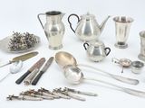 many different types of silverware on the table