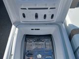 underside view of a white boat with the door open showing the inside of the boat