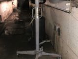 an image of a room with a metal stand in the middle of it