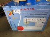 a box that has a sewing machine inside of it