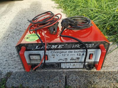 an electric charger sitting on the side of the road