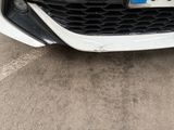 a picture of a white car with a license plate on it