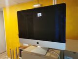 a computer monitor sitting on top of a desk