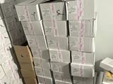 a pile of boxes stacked on top of each other in a room