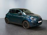 the small blue car is parked in a large room