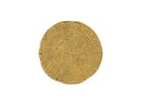 a close up of a gold coin on a white surface