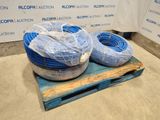 two blue hoses are on a pallet in front of a sign