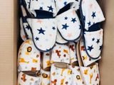 many pairs of baby shoes in a cardboard box