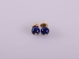 a pair of earrings with blue beads on a white background