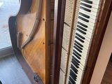 a piano that is sitting in the corner of a room