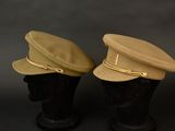 two hats on a mannequin head on a black background