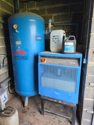 a blue tank sitting next to a blue heater in a garage