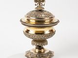 a gold plate with a bird on top of it