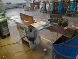 a machine that is cutting a piece of wood in a factory