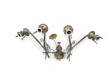 a metal wall light that has a bunch of flowers on it