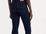 the back of a woman in a white top and blue jeans