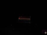 a bench in the middle of the dark with a light on