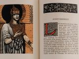 an open book with a picture of a woman holding a sword