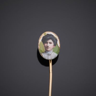a close up of a wooden stick with a picture of a woman on it