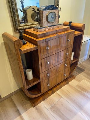 a wooden cabinet with a clock on top of it