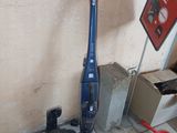 a vacuum that is sitting on the floor next to a sign