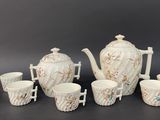 an image of a group of cups and a teapot on a table