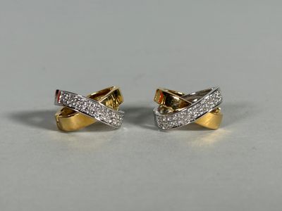 a pair of gold and diamond earrings on a white surface