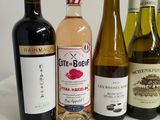 several bottles of wine are lined up on a table