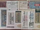 several different types of paper money sitting on top of a wooden table