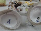 two white vases with blue letters on them on a table