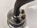 a close up of a metal object on a white surface