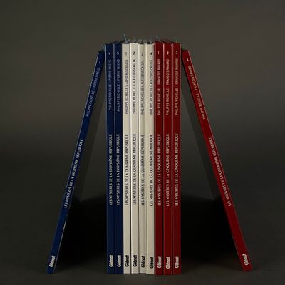 several books are stacked on top of each other on a table