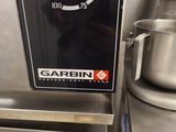 a close up of a large metal mixer on a counter