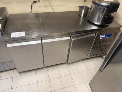 a stainless steel counter with a coffee maker on top of it
