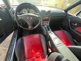 the interior of a car with red leather seats and a dashboard