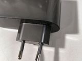 a black charger sitting on top of a white counter