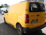 a yellow van that is parked in a parking lot