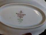 a white plate with a picture of a lighthouse on it