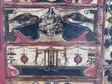 a chest of drawers that has a painting on it