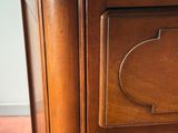 a close up of a wooden dresser with two drawers