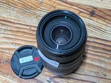 a camera lens sitting on top of a wooden table