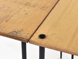a close up of a wooden table with metal legs