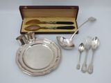 a silver plate with spoons and spoons in it