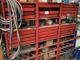 a red rack with lots of boxes and hoses on it