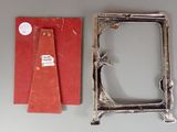 a picture of a silver picture frame and a red piece of paper