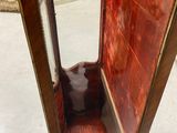 a wooden bench with a mirror on top of it