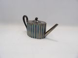 an image of a small teapot with a handle on a white surface