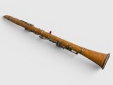a close up of a wooden flute on a white surface